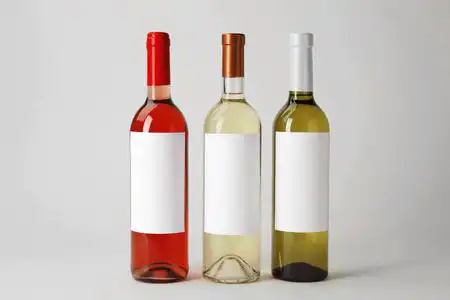 白色背景上有空白标签的可口葡萄酒瓶照片