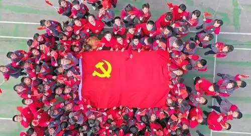 2021年2月28日,浙江省台州市仙居县外语学校小学部,孩子们与党旗合影.