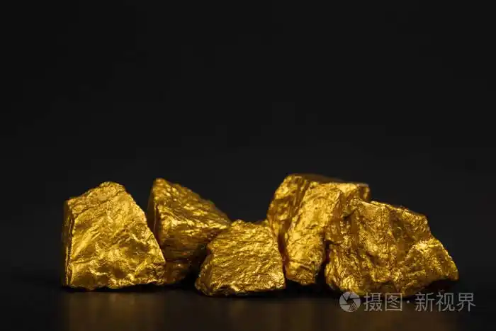 一堆金块或金矿石上的黑色背景宝石或一块金石金融和商业概念